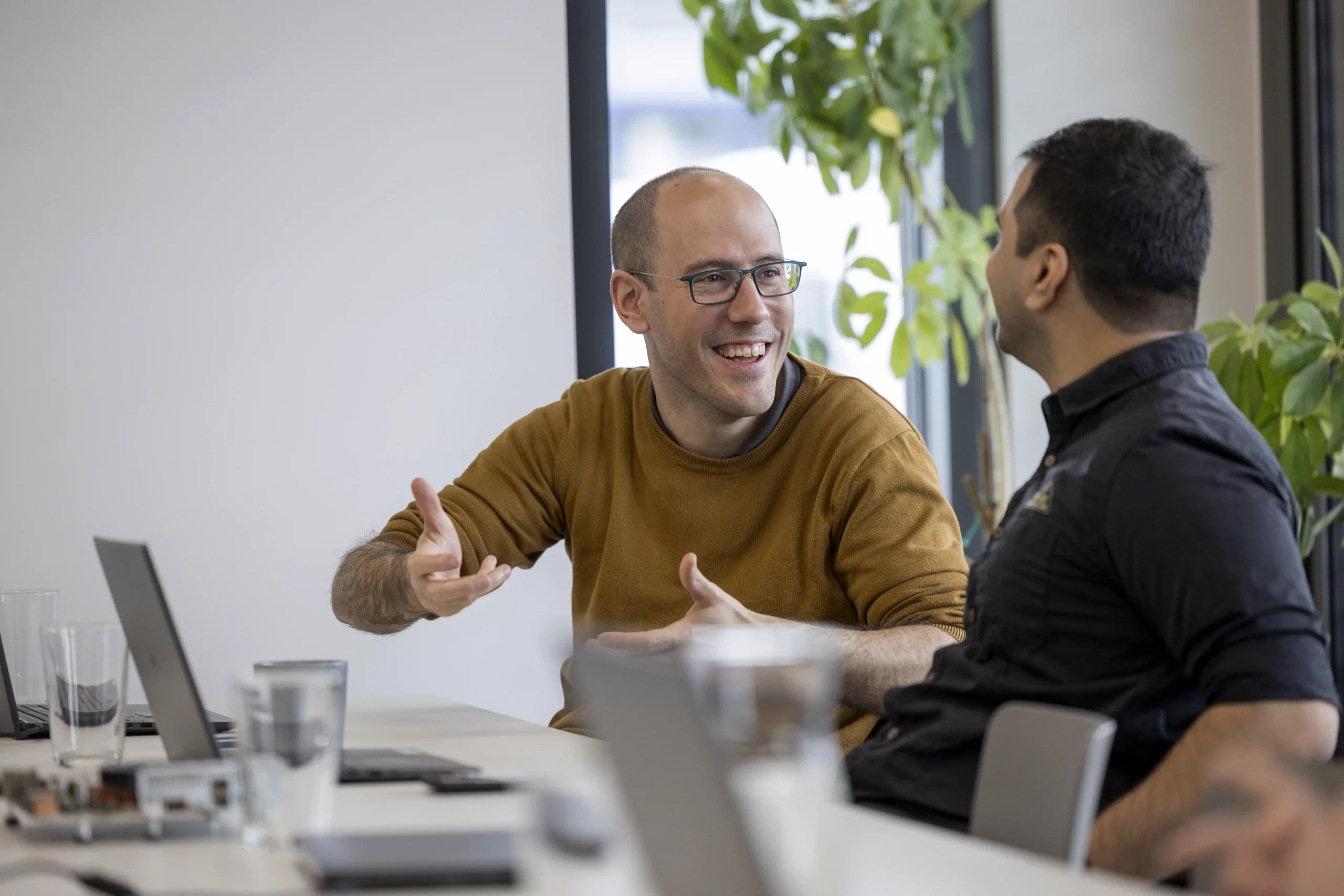 PLC2 employees in direct conversation during their daily work